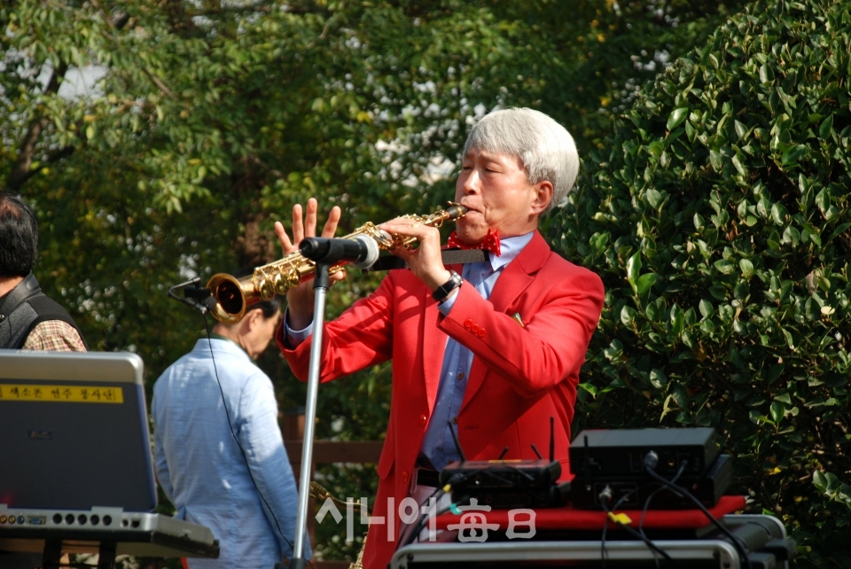 망우당공원 무료급식소에서 색스폰 연주를 하고 있다. 권오섭 기자