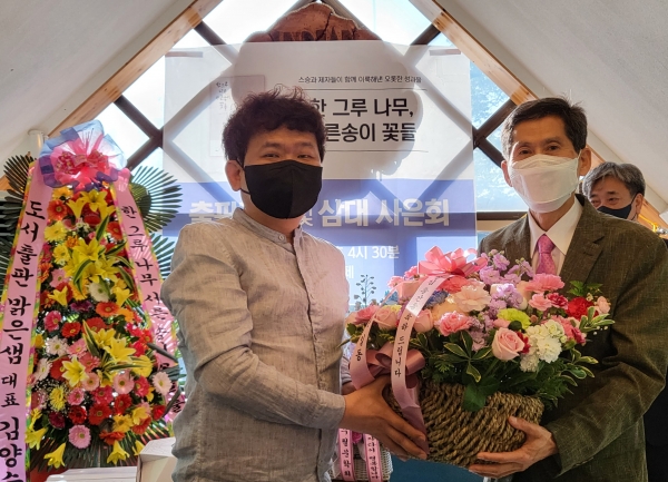 포곡수필문학회 이진우 수필가가 스승 곽흥렬 수필가에게 축하 꽃바구니를 전달하고 있다. 정양자 기자