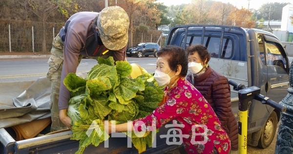 초원파크경로회원들이 배추 팔아주기 운동에 나선 가운데 트럭에서 배추를 내리고 있다. 정나겸 기자